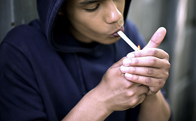 cannabis-children-v1 teenager exhaling cannabis smoke, feeling cool, harming health